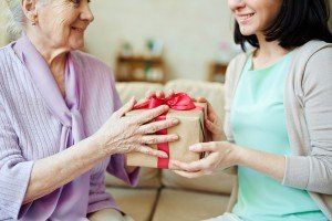 iStock-517075152_elderly-senior-woman-gift-caregiver-daughter-sitting-smiling-300x200.jpg