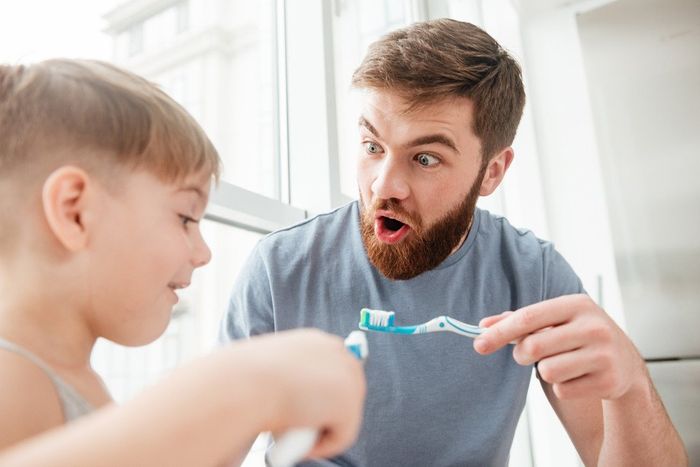 graphicstock-father-and-son-smiling-while-brushing-teeth-in-bathroom-look-at-each-other_H_7M6giLnl_PMNW.jpg