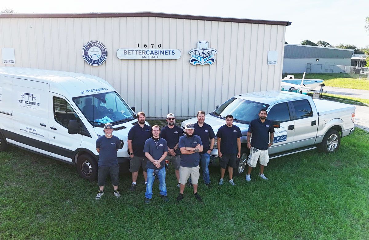 Better Cabinets & Bath crew standing with company vans and a truck outside their shop