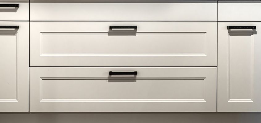 Refaced white shaker drawer fronts with matte black pulls