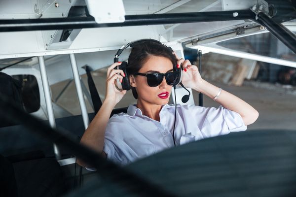graphicstock-pretty-young-woman-pilot-in-headset-ready-to-fly-in-small-airplane_BOli5rrhl_PMNW.jpg