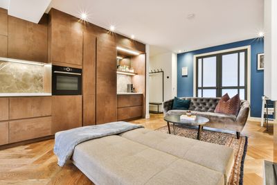 Living room with a sofa bed and wood wall cabinets