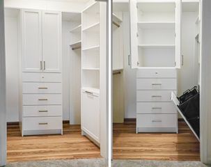 Small walk-in closet in Omaha with a white TFL shaker-style tower, multiple drawers, open shelving, and a tilt-out hamper shown open. Shaker Walk-In Closet, Omaha