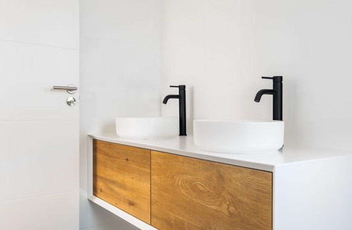 Floating double vanity with wood drawer fronts, white vessel sinks, and black faucets