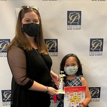 Another student being recognized by her instructor for her musical accomplishment