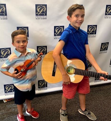 Brothers showing off their instruments