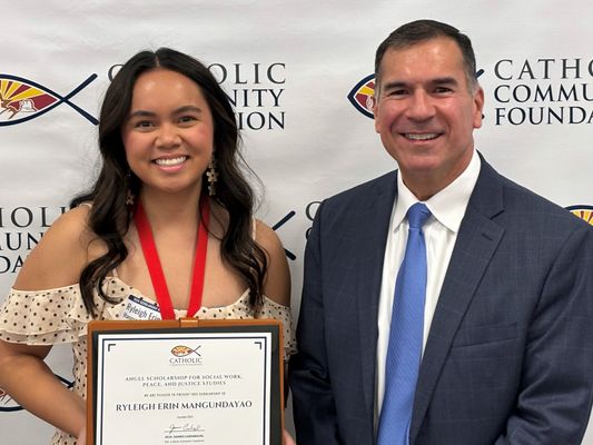 Scholarship recipient holding her certificate beside a CCF leader