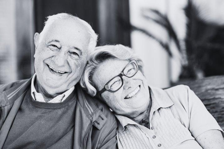 Black and white photo of a smiling older couple