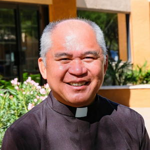 Pastor of Christ the King Parish smiling outdoors