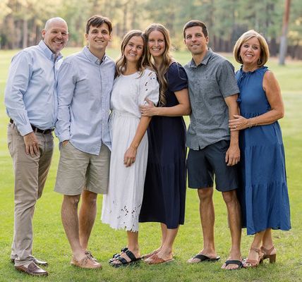 Deacon and his family standing together on a lawn