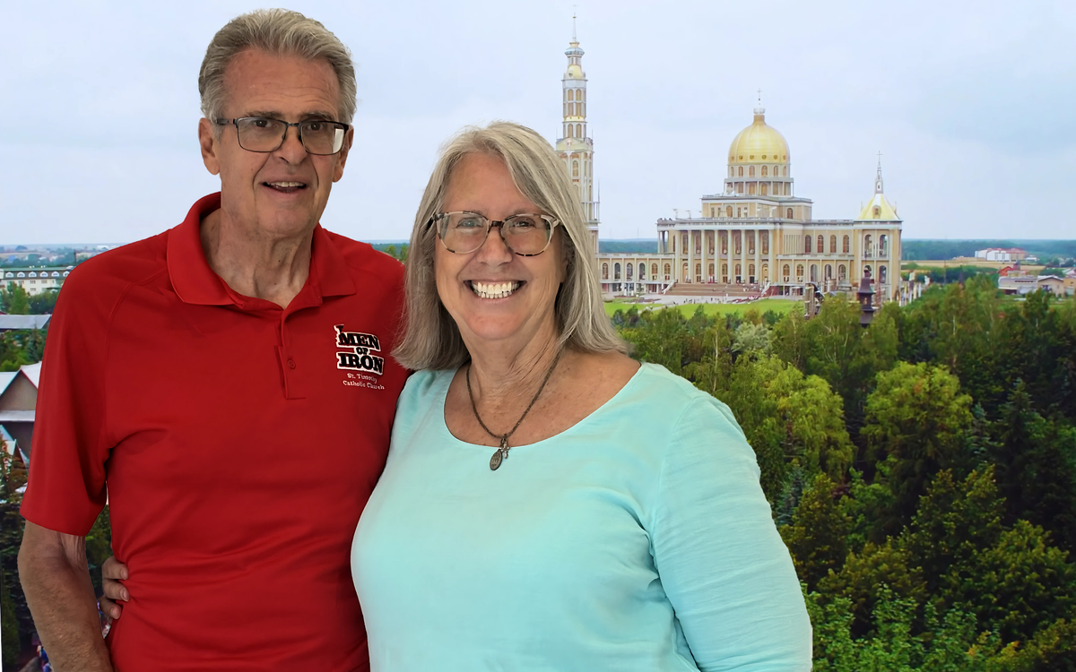 Couple posing in front of a basilica on a pilgrimage