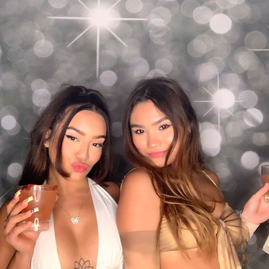 Two Women Posing with Drinks at Green Screen Photo Booth AZ