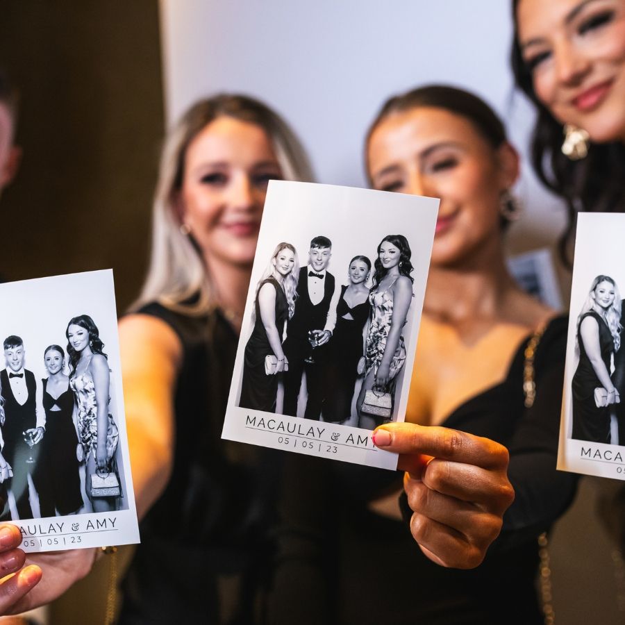 Group Holding Custom Event Photo Printouts - Green Screen Photo Booth AZ