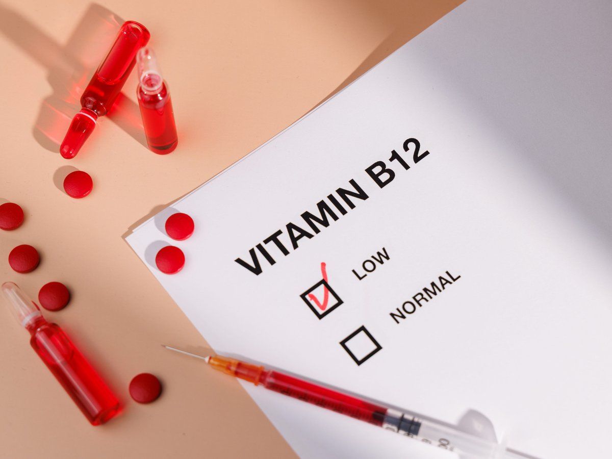 Vitamin B12 checklist marked low beside vials and a syringe